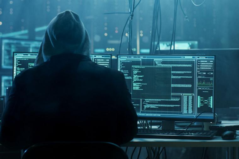 photo of person sitting at desk hacking