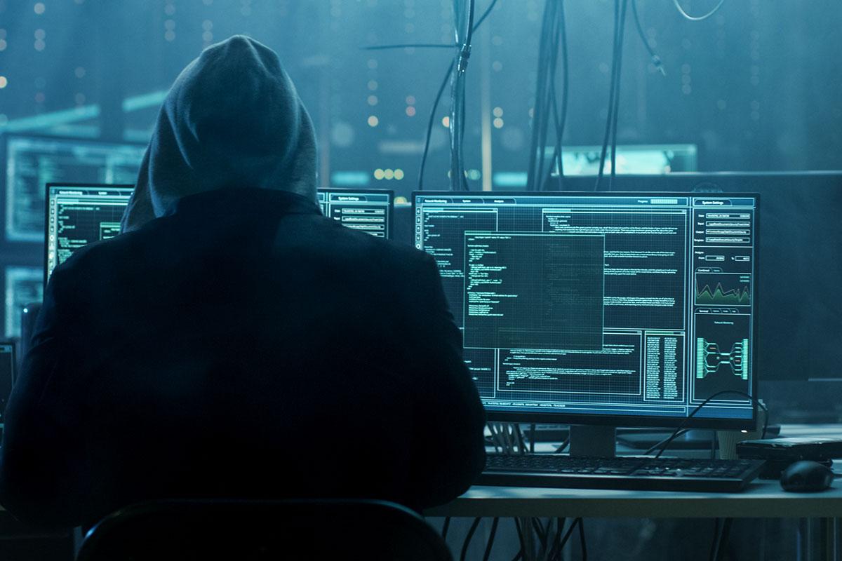 photo of person sitting at desk hacking