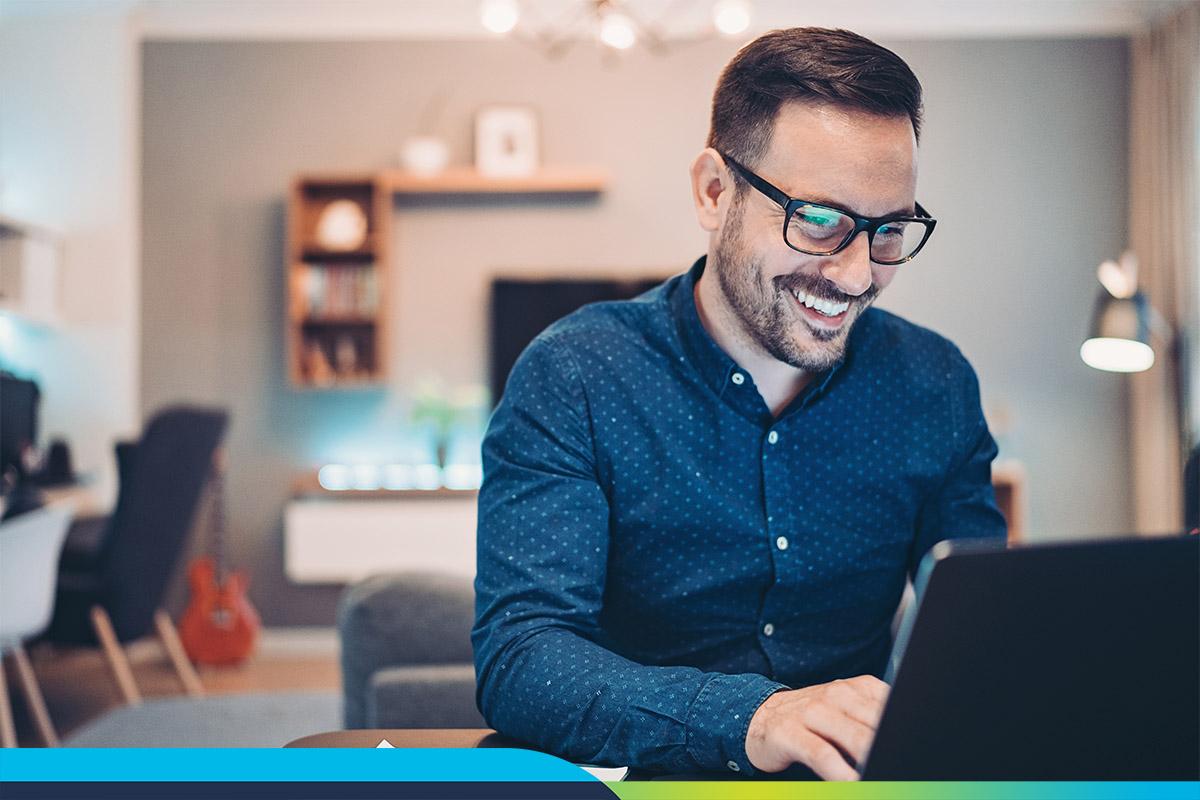 Man smiling working at laptop