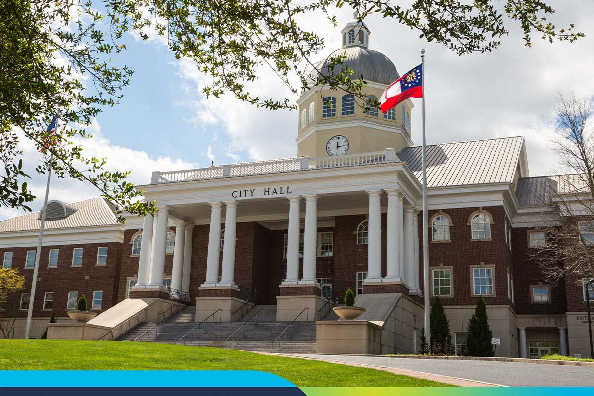 Image of a building with City Hall written on it and a flag outside