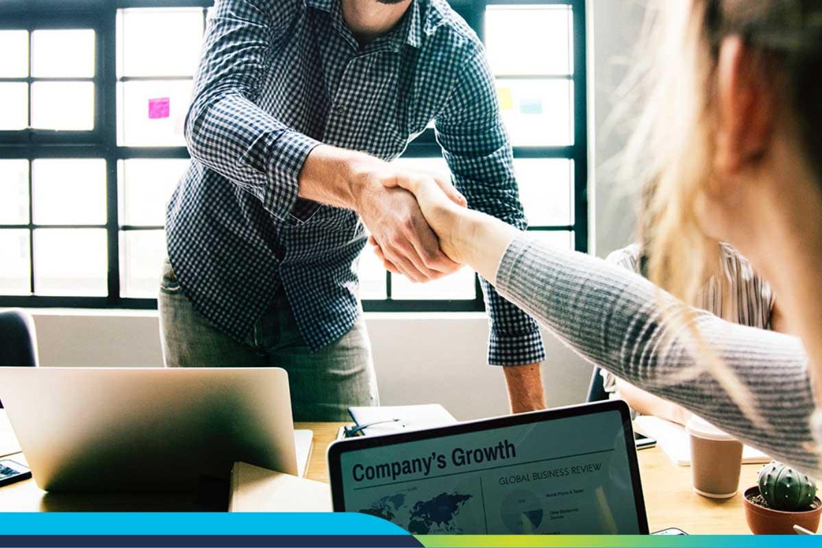 People shaking hands across a table